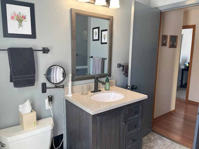 bathroom featuring vanity, toilet, and tile patterned floors