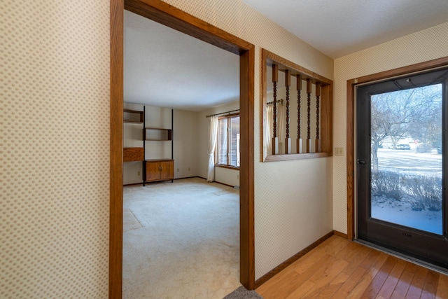 doorway to outside with light hardwood / wood-style floors