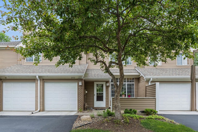 2752 Autumnwood Ln, Minnetonka, MN 55305 - multi unit property featuring an attached garage, a shingled roof, and driveway