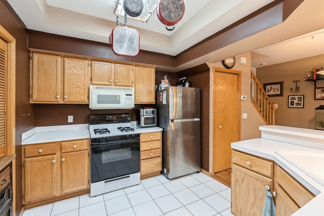 2752 Autumnwood Ln, Minnetonka, MN 55305 - kitchen featuring white appliances, light countertops, a raised ceiling, and light tile patterned floors