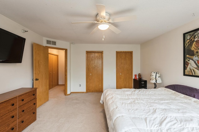 2752 Autumnwood Ln, Minnetonka, MN 55305 - bedroom with light colored carpet, two closets, and a ceiling fan