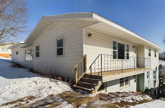 view of snow covered back of property