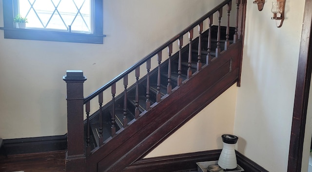 stairs with baseboards and wood finished floors