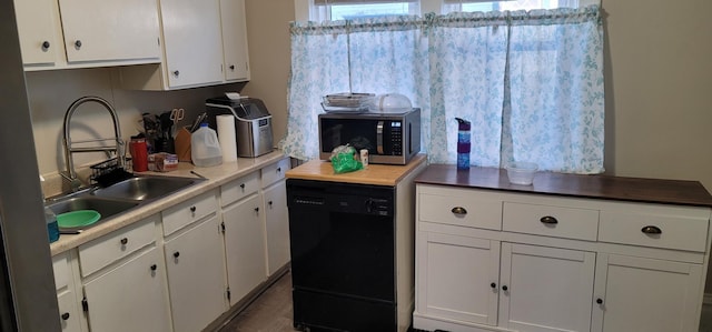 kitchen featuring light countertops, stainless steel microwave, white cabinets, a sink, and dishwasher
