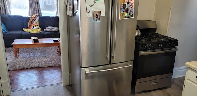 kitchen featuring appliances with stainless steel finishes and wood finished floors