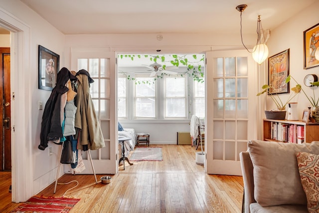 interior space featuring baseboards and wood-type flooring