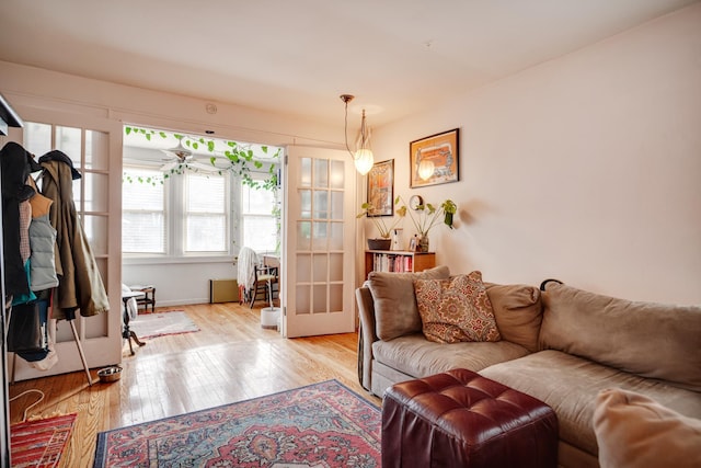 living area with light wood-style flooring and french doors