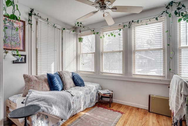 sunroom / solarium featuring a ceiling fan