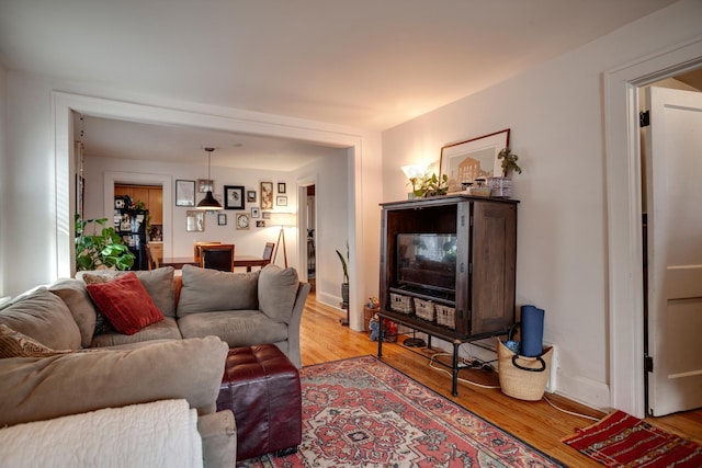 living room with light wood-style flooring and baseboards