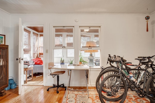 dining room featuring light wood-style floors and ornamental molding