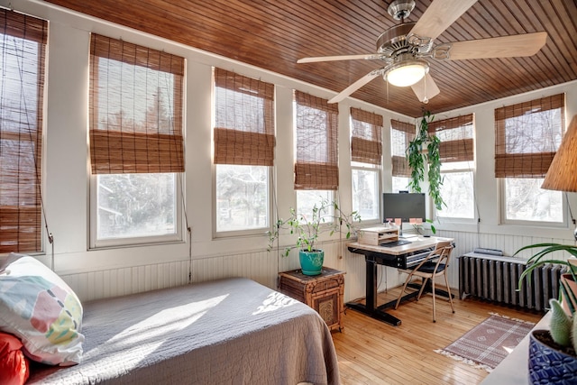 bedroom featuring wood ceiling, light wood-type flooring, and radiator heating unit