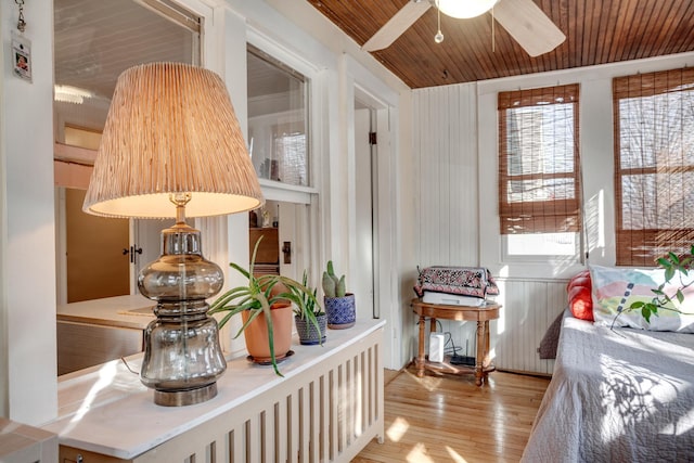 sitting room featuring ceiling fan, light wood-type flooring, and wooden ceiling