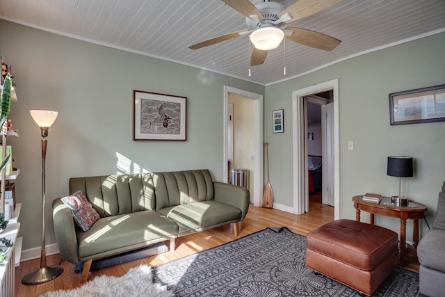 living area featuring wood finished floors and ornamental molding