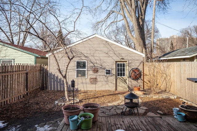 back of property featuring a fenced backyard and a fire pit