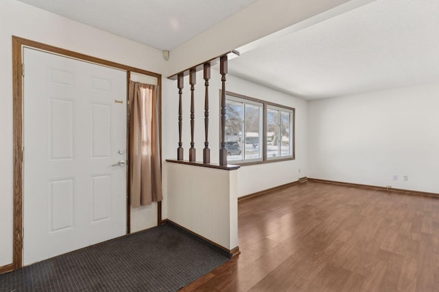 foyer featuring dark wood-type flooring and a textured ceiling