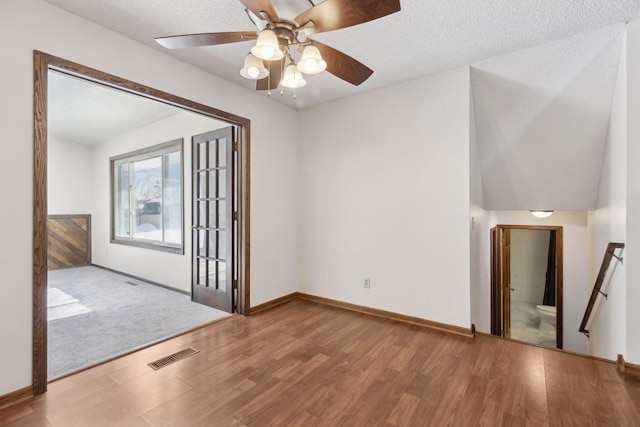 unfurnished room featuring a textured ceiling, hardwood / wood-style floors, and ceiling fan