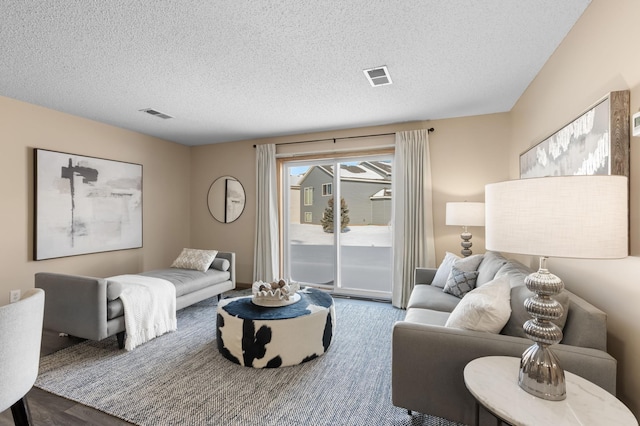 living room featuring hardwood / wood-style flooring and a textured ceiling