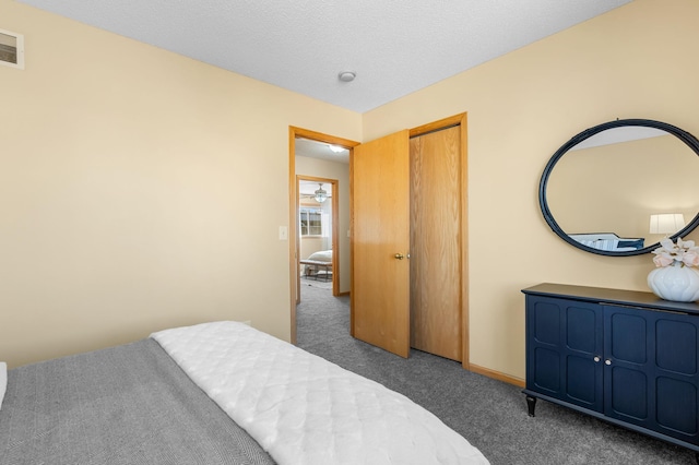 carpeted bedroom featuring a textured ceiling