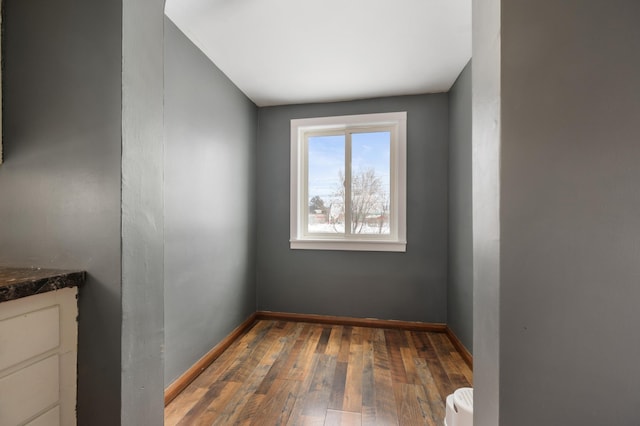 empty room with dark hardwood / wood-style floors