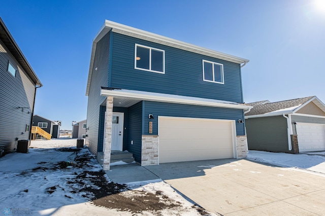 view of front facade with stone siding, entry steps, concrete driveway, and an attached garage