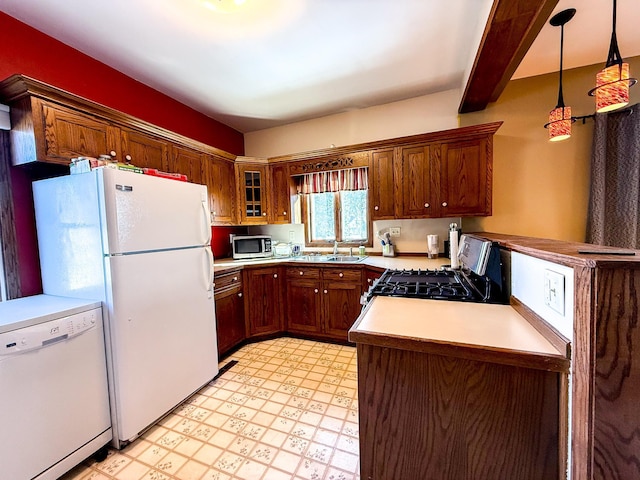 kitchen with a sink, light floors, appliances with stainless steel finishes, and light countertops