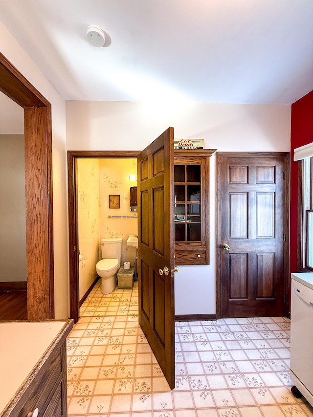 bathroom featuring tile patterned floors, toilet, and baseboards