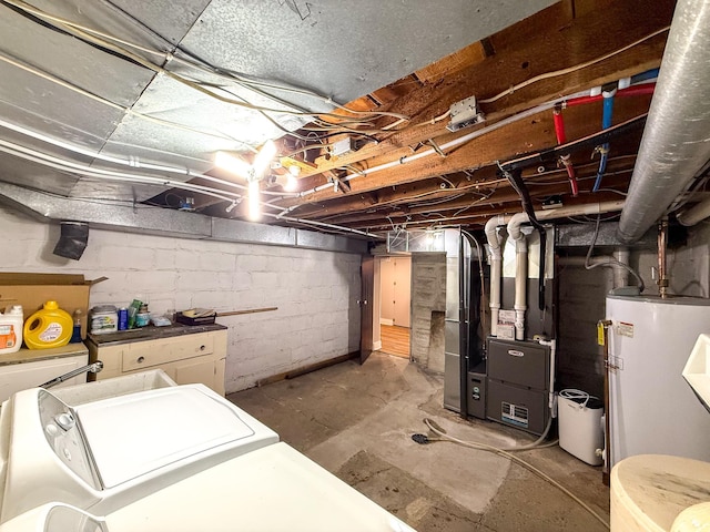 unfinished below grade area featuring water heater, heating unit, and washer / dryer