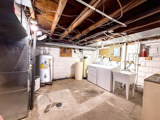 unfinished basement with washer and clothes dryer, electric water heater, and a sink