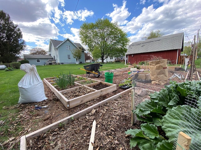 view of yard with an outdoor structure, a vegetable garden, and a shed