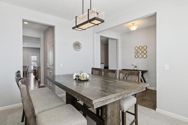 dining room featuring carpet and baseboards