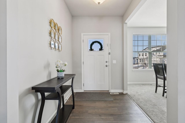 entryway featuring baseboards and dark wood finished floors