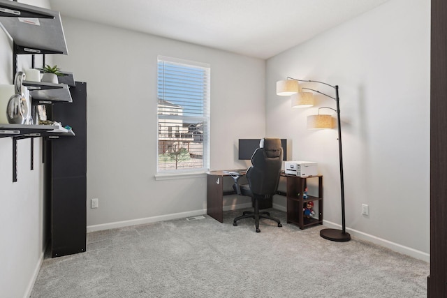 home office with light carpet, plenty of natural light, and baseboards