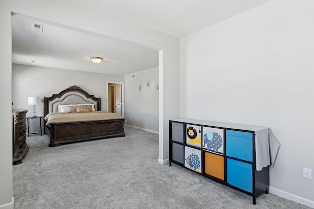 bedroom with carpet floors, visible vents, and baseboards