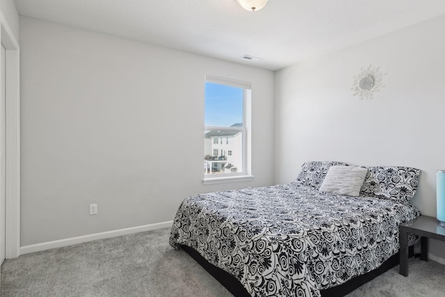 carpeted bedroom featuring visible vents and baseboards