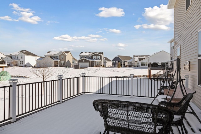 snow covered patio with a residential view