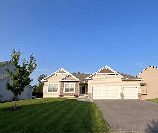 craftsman house with a garage and a front lawn