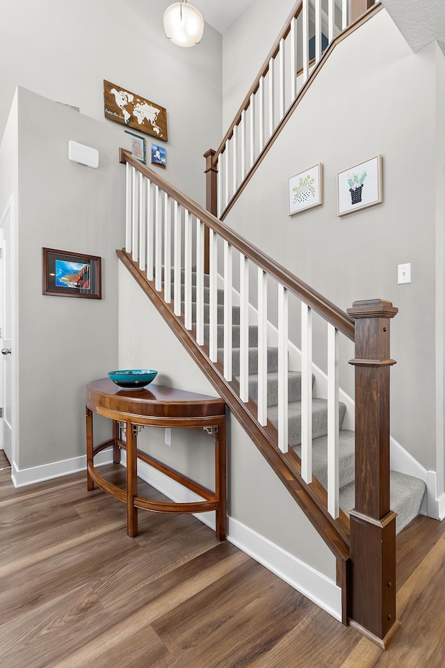 stairs featuring wood-type flooring