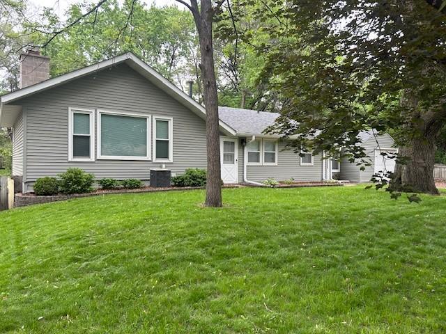 541 105th Ln NW, Coon Rapids, MN 55448 - ranch-style house featuring a chimney and a front lawn