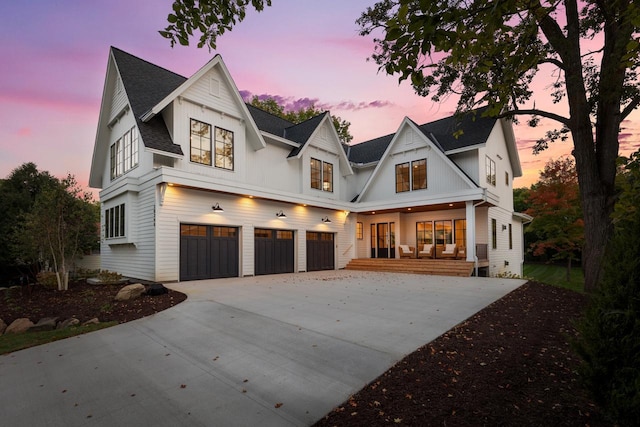 modern farmhouse featuring a garage and covered porch