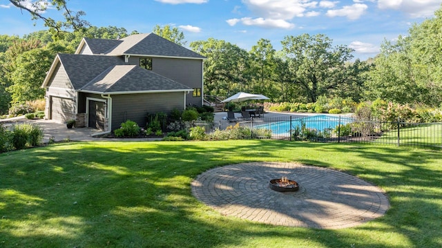 view of pool featuring a fenced in pool, fence, a lawn, and an outdoor fire pit