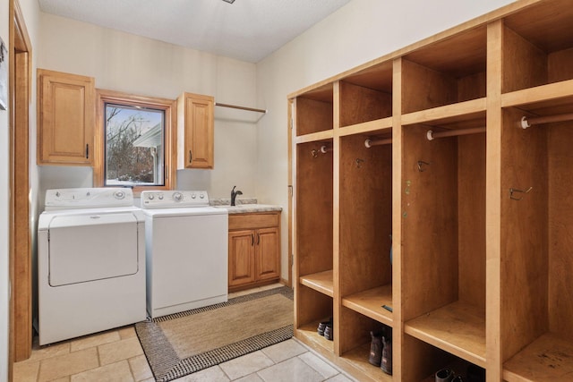 laundry area with a sink, cabinet space, and washing machine and dryer