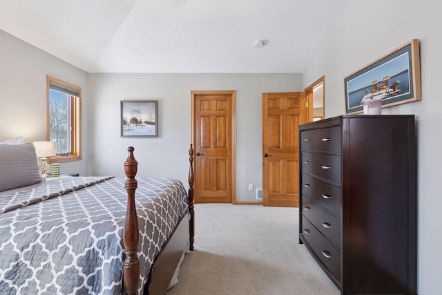 bedroom featuring baseboards, light carpet, a textured ceiling, and vaulted ceiling