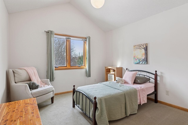 bedroom with baseboards, lofted ceiling, and carpet