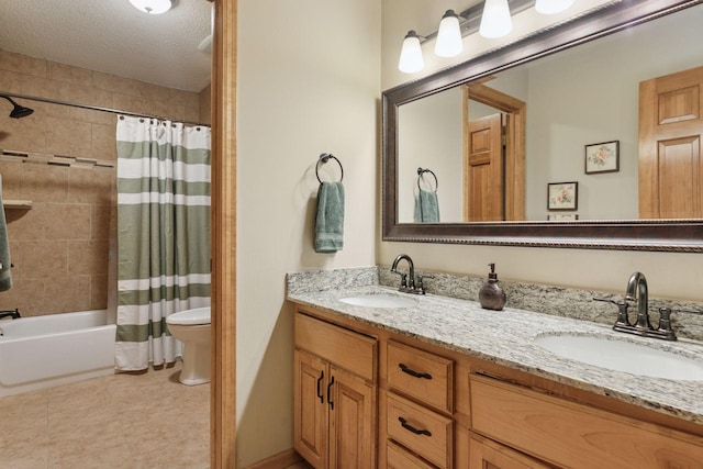 bathroom featuring double vanity, toilet, shower / bath combo with shower curtain, and a sink