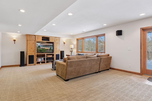 living room with recessed lighting, baseboards, and light carpet