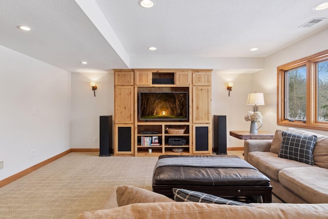 living room featuring light carpet, recessed lighting, a textured ceiling, and baseboards