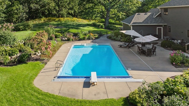 view of swimming pool with a fenced in pool, a patio, and a lawn