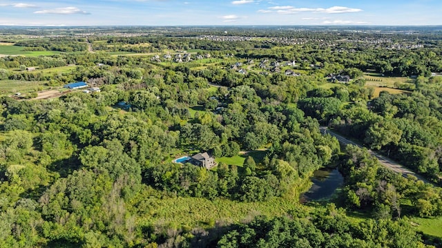 birds eye view of property with a view of trees