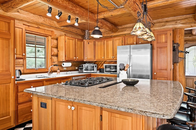 kitchen featuring stainless steel appliances, a kitchen island, wooden ceiling, and sink