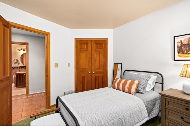 bedroom with tile patterned floors and a closet